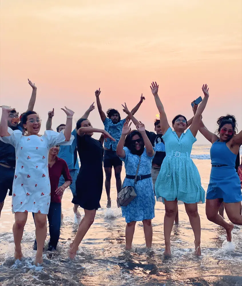 Procedure team jumping at the beach during a Goa offsite